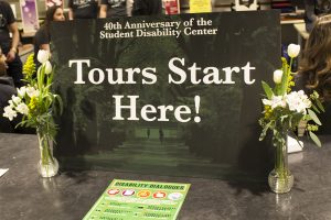 A sign on a desk that reads "Tours start here".